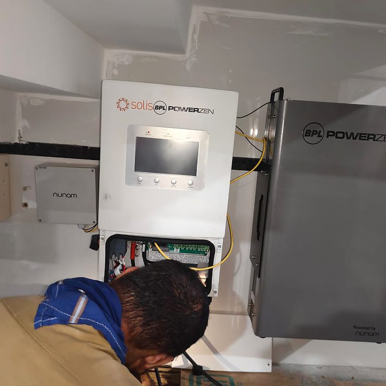 Technician commissioning a wall-mounted system